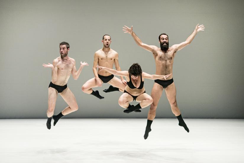 Four dancers in the performance. All of them have jumped up in the air.