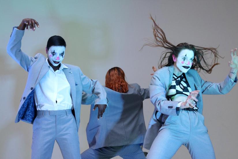 Three performers in blue suits