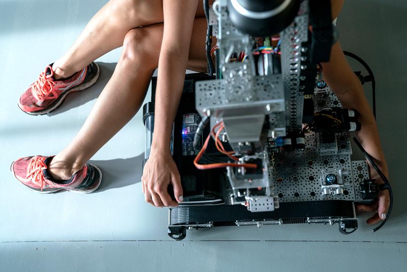 Photo: Vesa-Pekka Grönfors A dancer sitting on top of a robot, or on its lap