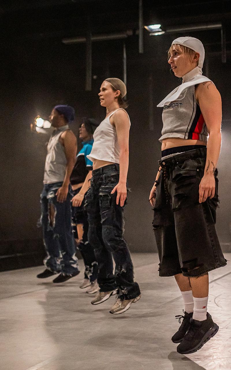 Four performers have jumped straight up in the air.