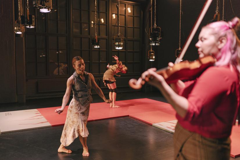 Three performers on stage.