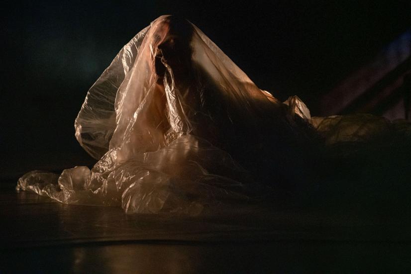 Photo: Petra Tiihonen A person undert white plastic