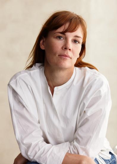 Photo: Ilkka Saastamoinen Jenni-Elina Von Bagh looking at the camera sitting down on a beanch. She has a white shirt.