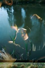 Dancers Johan Högsten and Anna Maria Häkkinen with their hands raised, photo of a pond layered over their photo