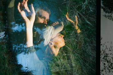 Dancers Johan Högsten and Anna Maria Häkkinen with their hands raised, photo of a pond layered over their photo