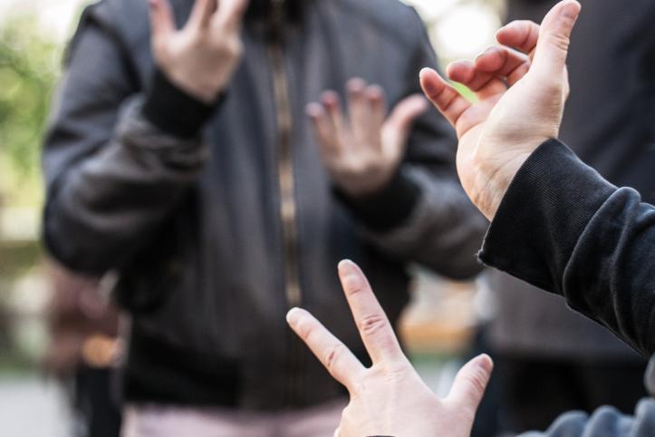 Two people communicating with their hands