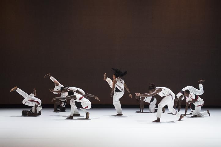 A big group of dancers. They are all wearing white.