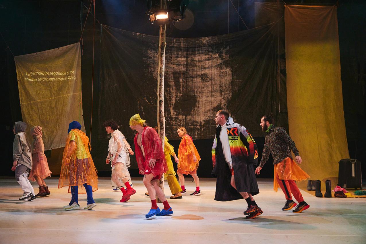 Dancers in the performance. They are wearing colourful clothes.