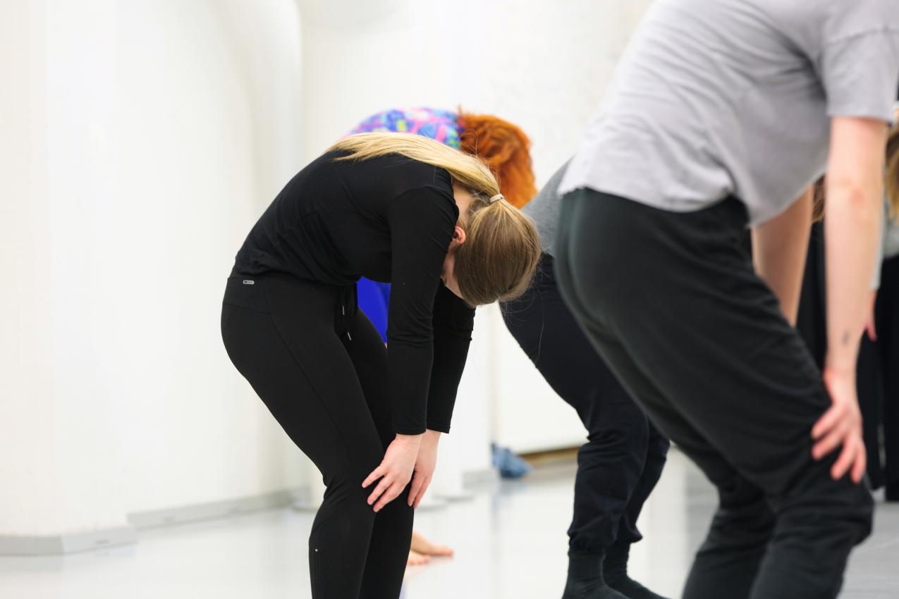 A person stretching in the dance studio