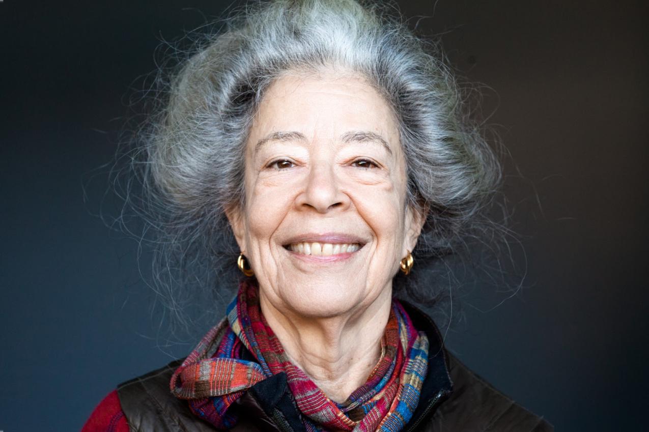 A grey haired woman smiling