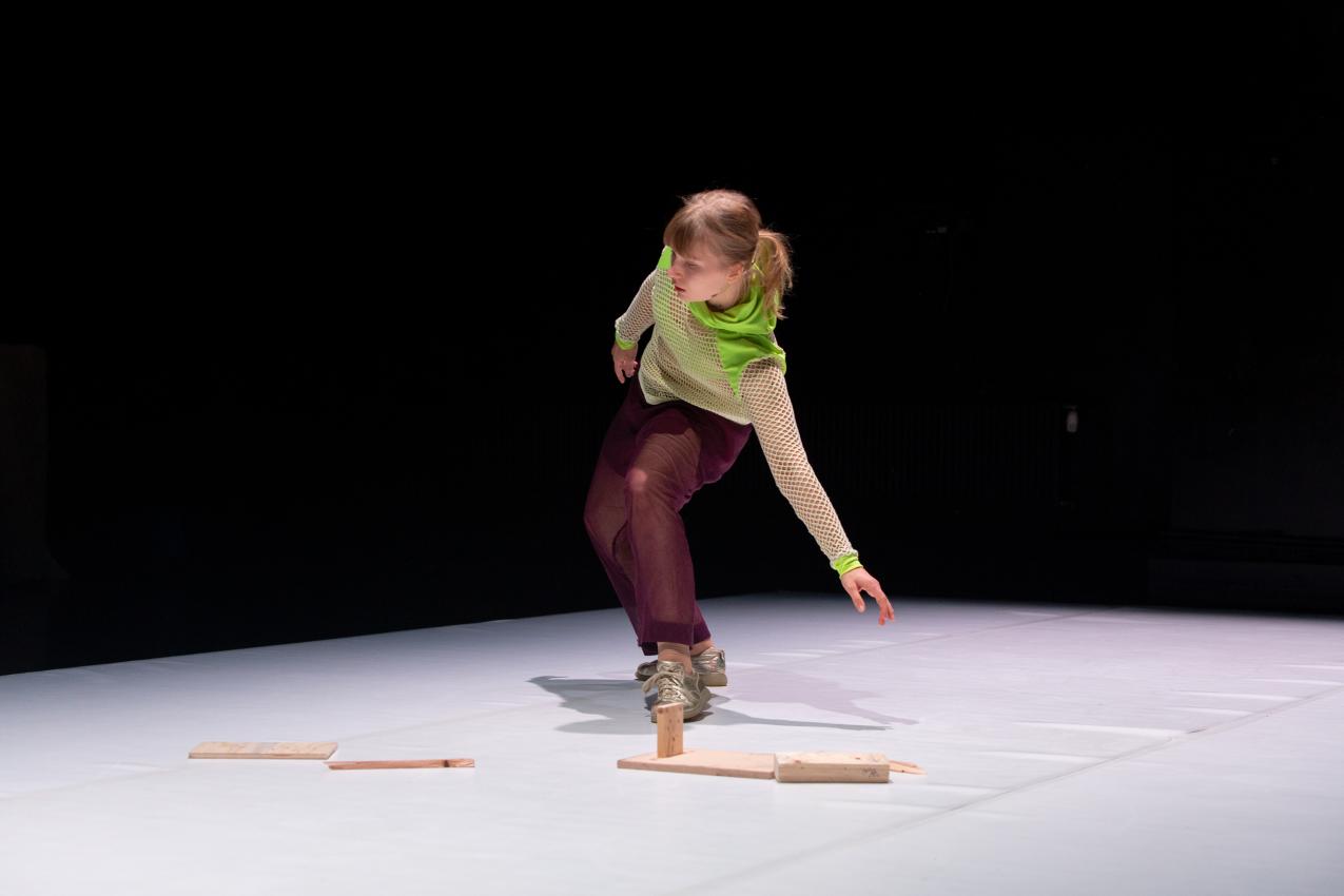 Eeva Juutinen dancing in a dark space