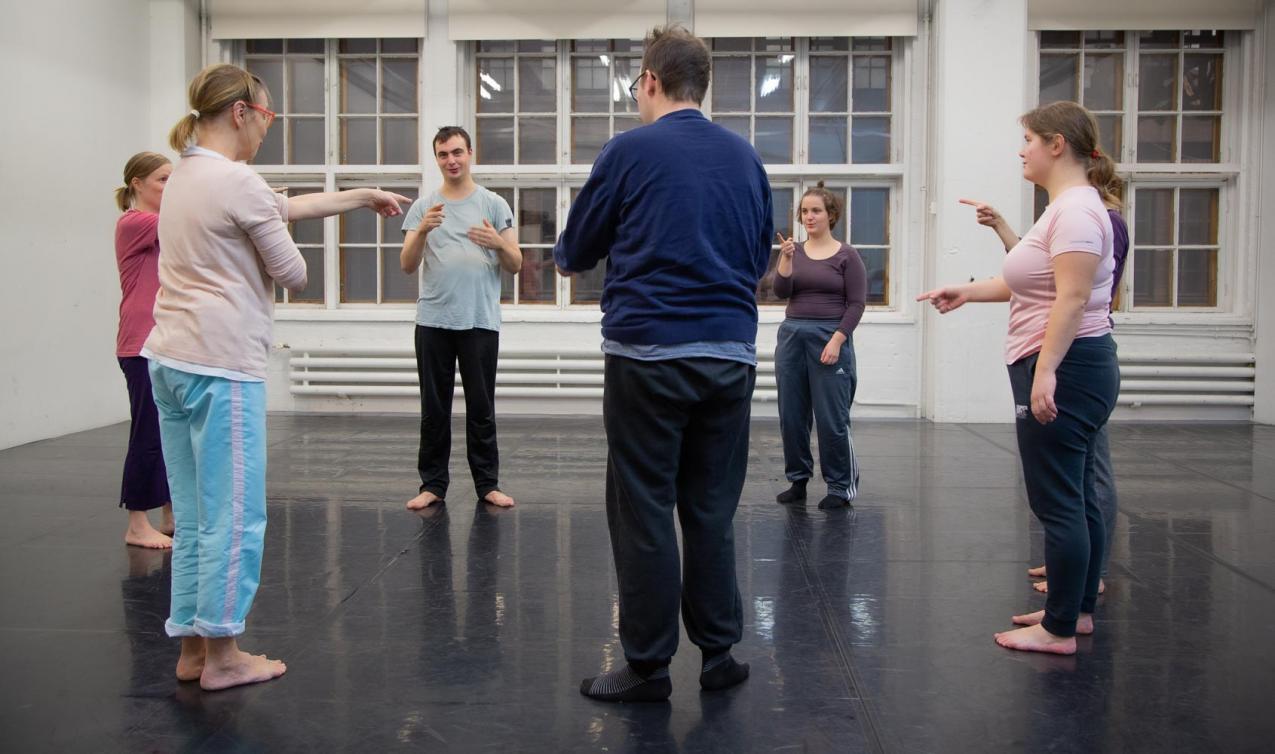 Several people standing and forming a circle.