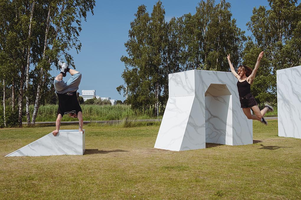 The Wall at Töölönlahti park. Two people are dancing next to it.