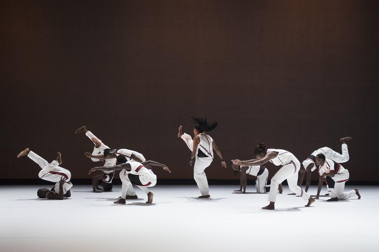 A big group of dancers. They are all wearing white.