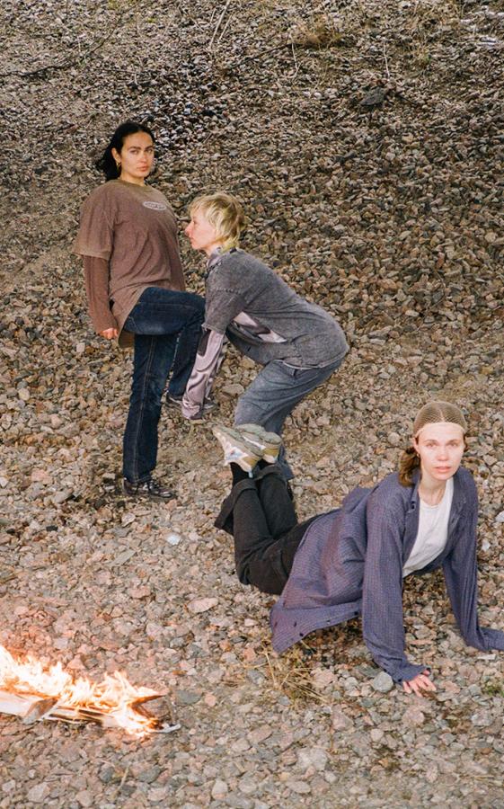 PR photo.There are three people in the photo. The ground is made of pebbles.