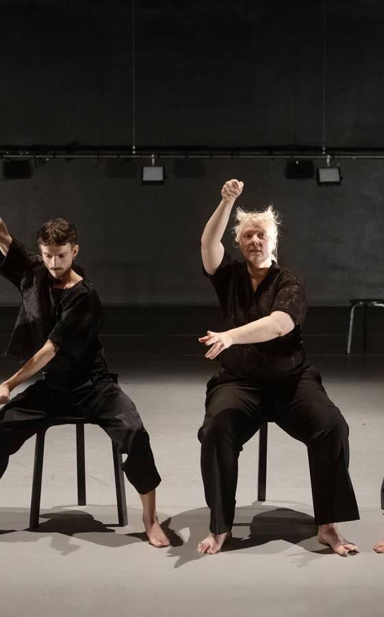 Four performers ons tage, dressed in black.