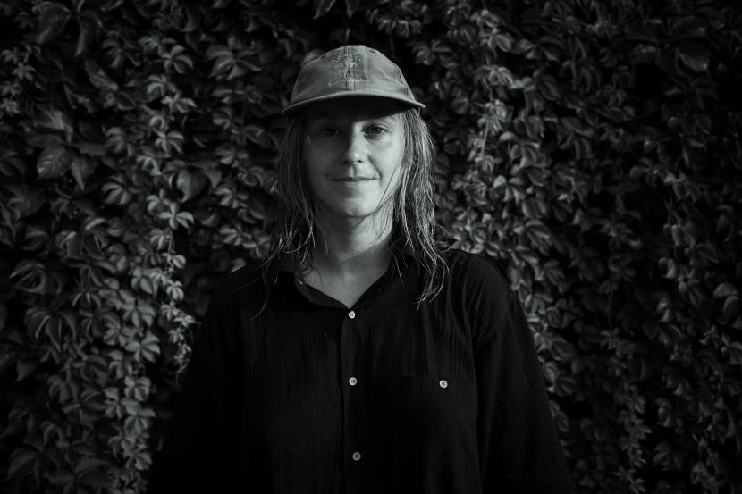 Linda Blomqvist from the waist up in a black and yellow shirt. She is facing diagonally to the camera.
