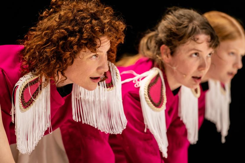 Three dancers in their red clothing