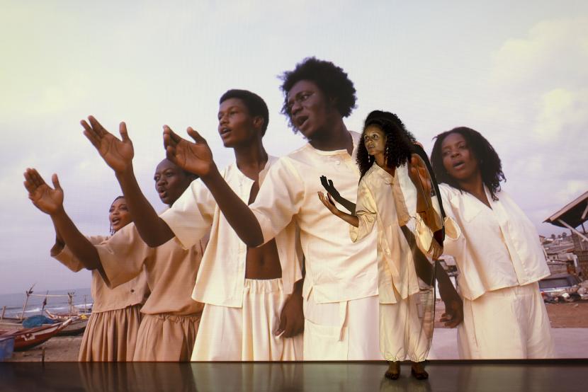 Kuvassa näkyy kankaalle heijastettu kuva. Yksi henkilö seisoo kuvan edessä.